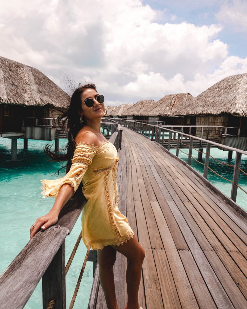 Christina at the Four Seasons Bora Bora walkway to overwater bungalows | The Ultimate Bora Bora and Moorea travel guide