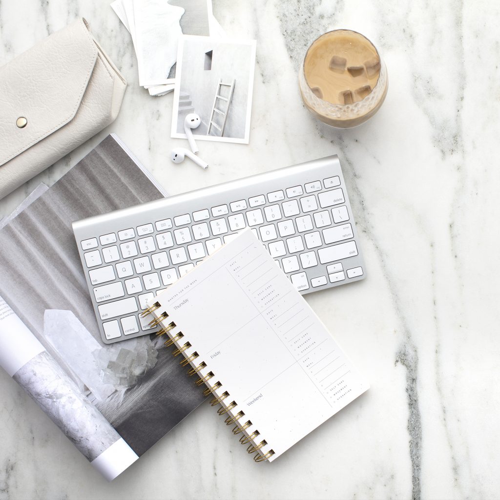 Desk keyboard and notebook | How to Decide What Kind of Product to Create for Your Audience